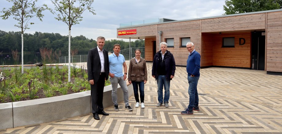 Bürgermeister Rainer Doetkotte, Stadtbaurat Ralf Groß-Holtick sowie die verantwortlichen Mitarbeitenden der Stadtverwaltung vor dem neuem Sanitärgebäude am Dreiländersee.